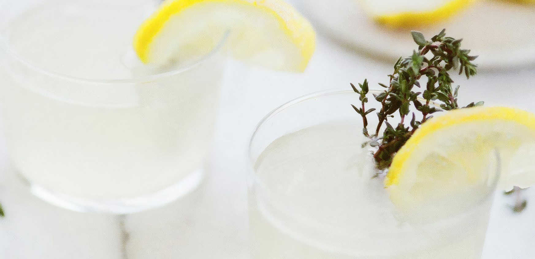 Lemon and thyme spritz glasses on a white table