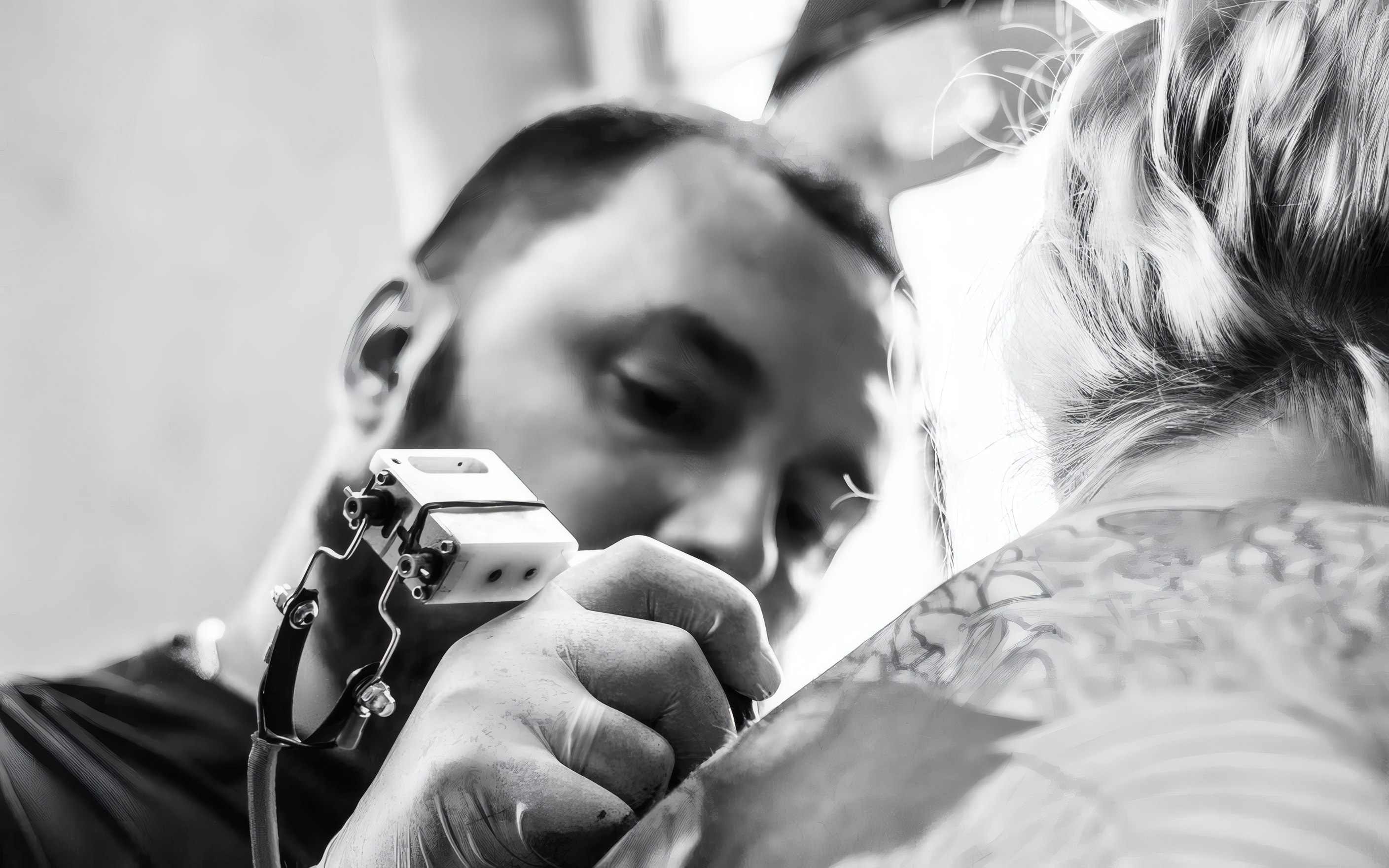 A tattoo artist working on a back piece