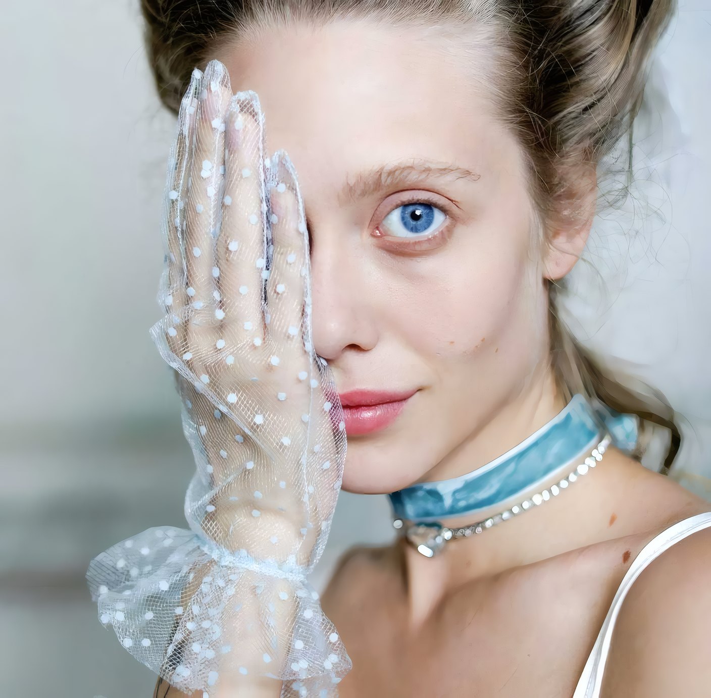 A woman in a lace glove and a pearl choker