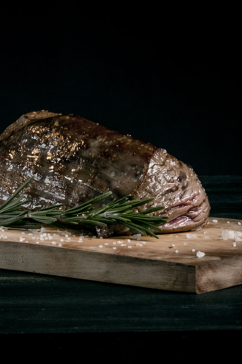 A dry-aged steak resting on a board