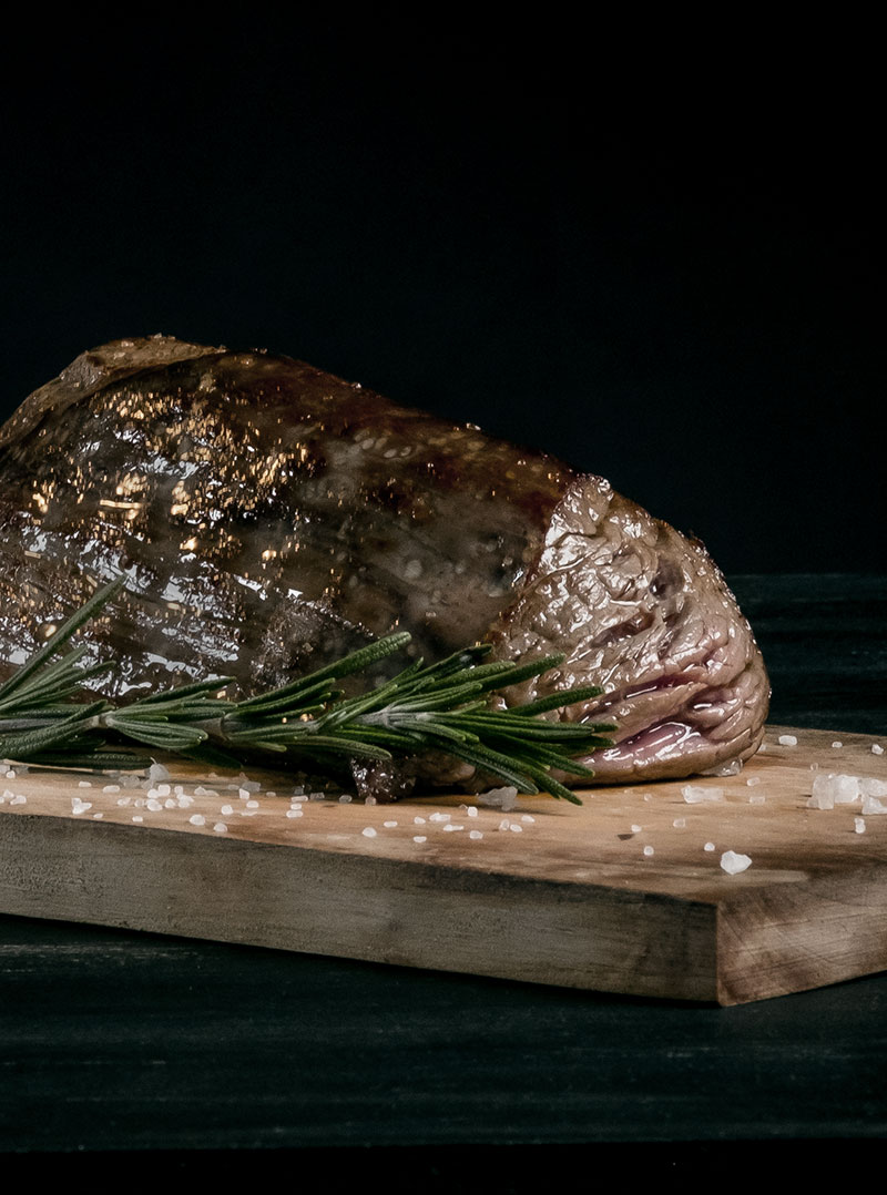 A dry-aged steak resting on a board