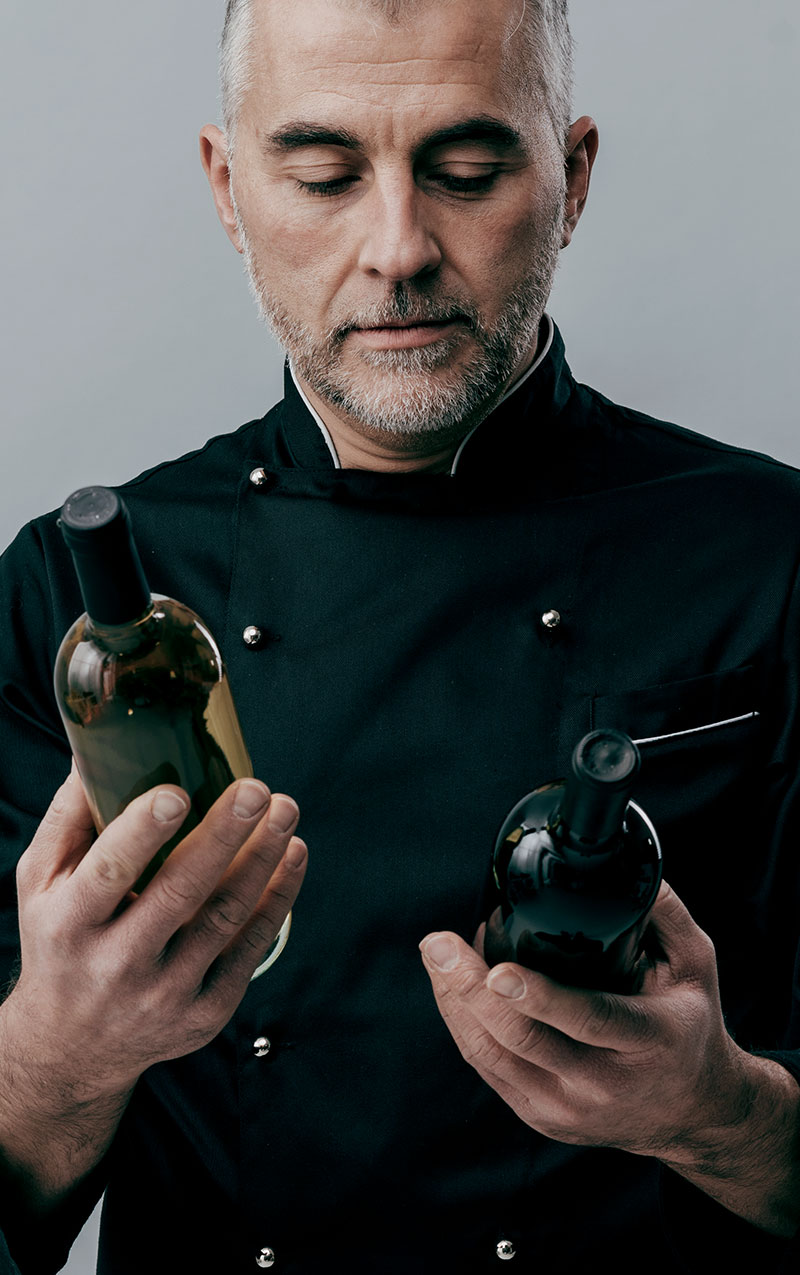 Marco Ferrante choosing a bottle for the table