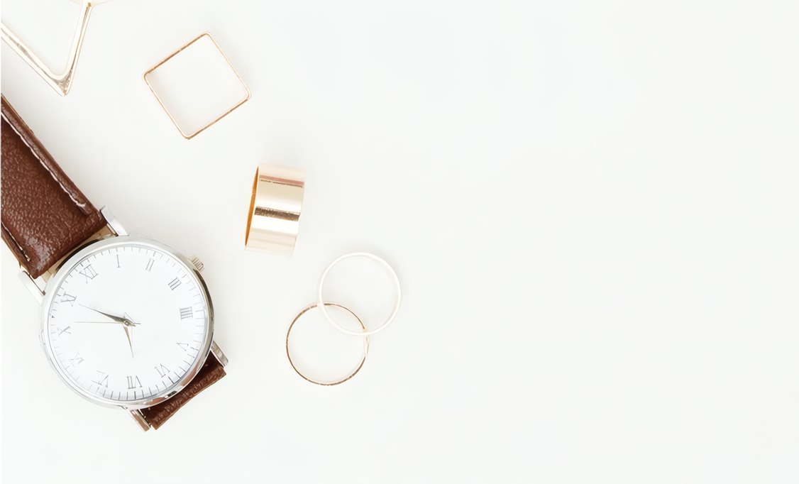 A nude strap watch and gold rings
