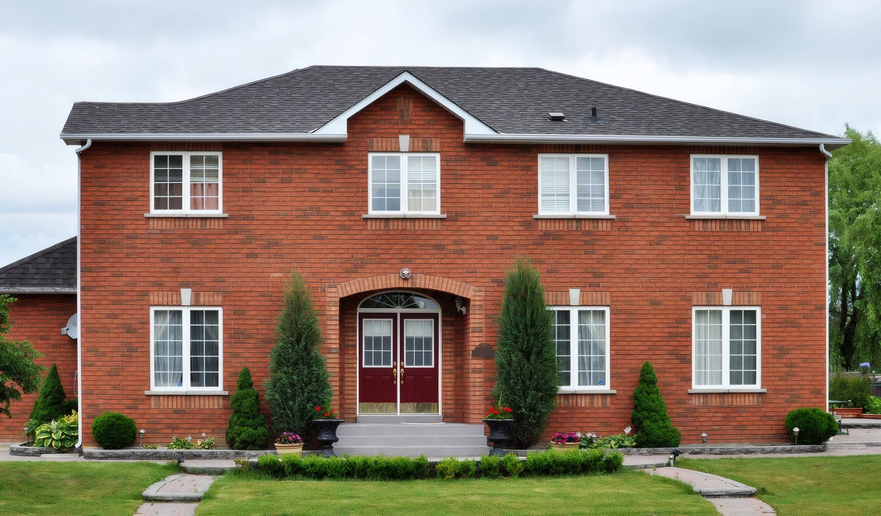 Carelia House, a red brick home with a garden