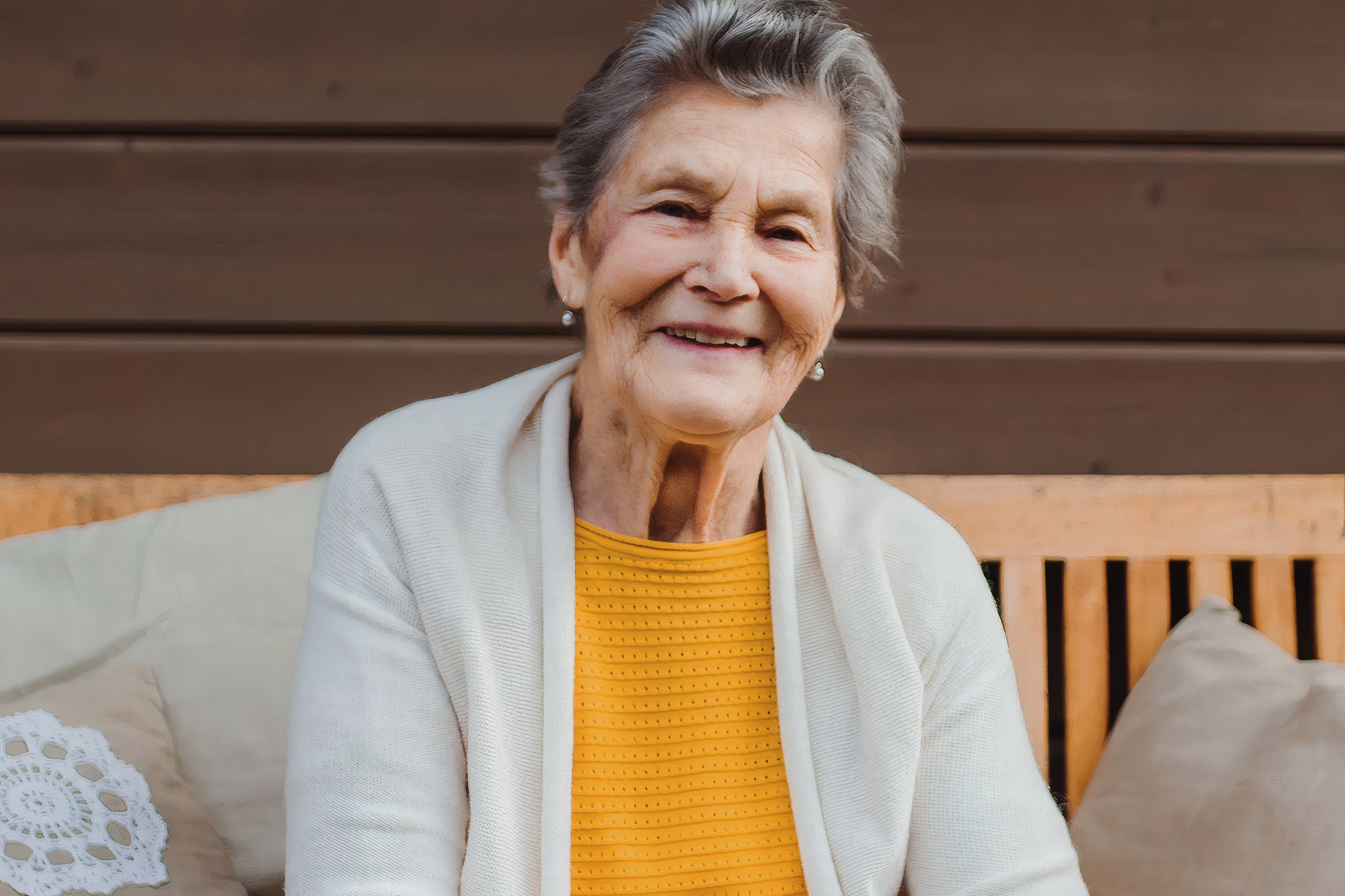 A smiling resident in a yellow jumper