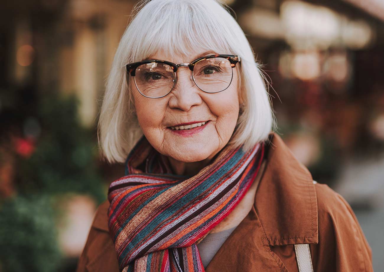 A smiling resident in a red scarf