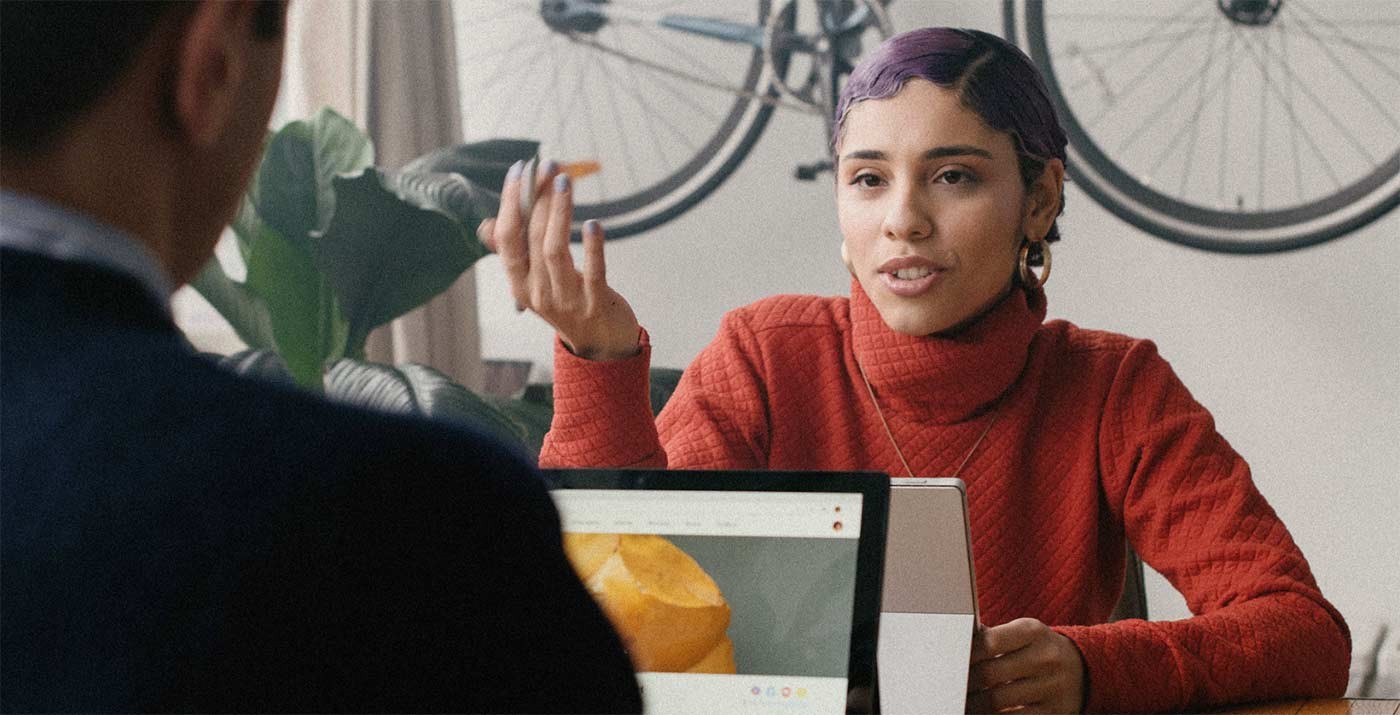 Two colleagues talking at a desk
