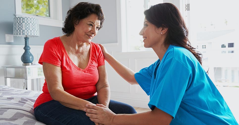 A nurse checks in on a patient in the waiting area