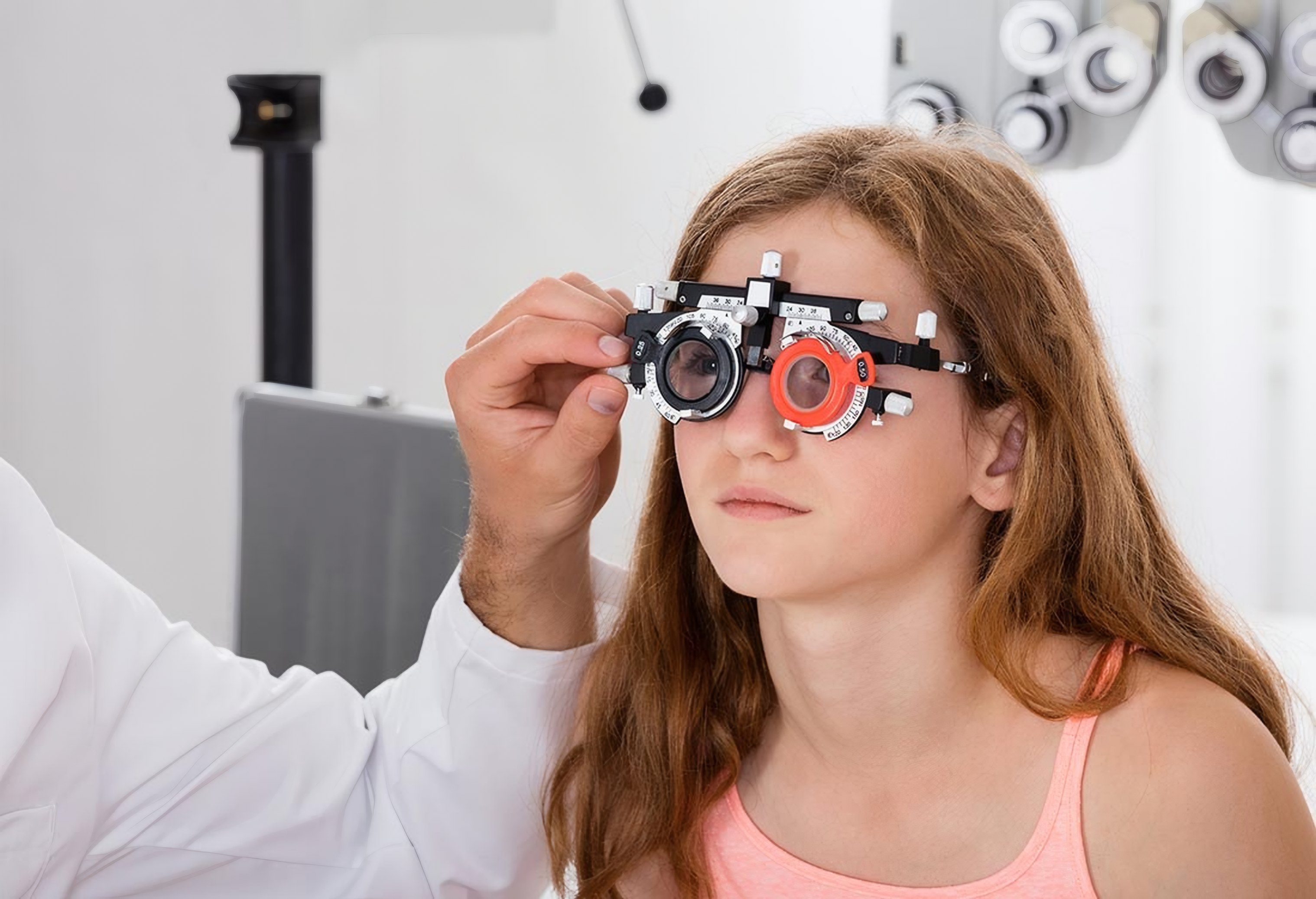 A girl wears a trial frame during an eye test