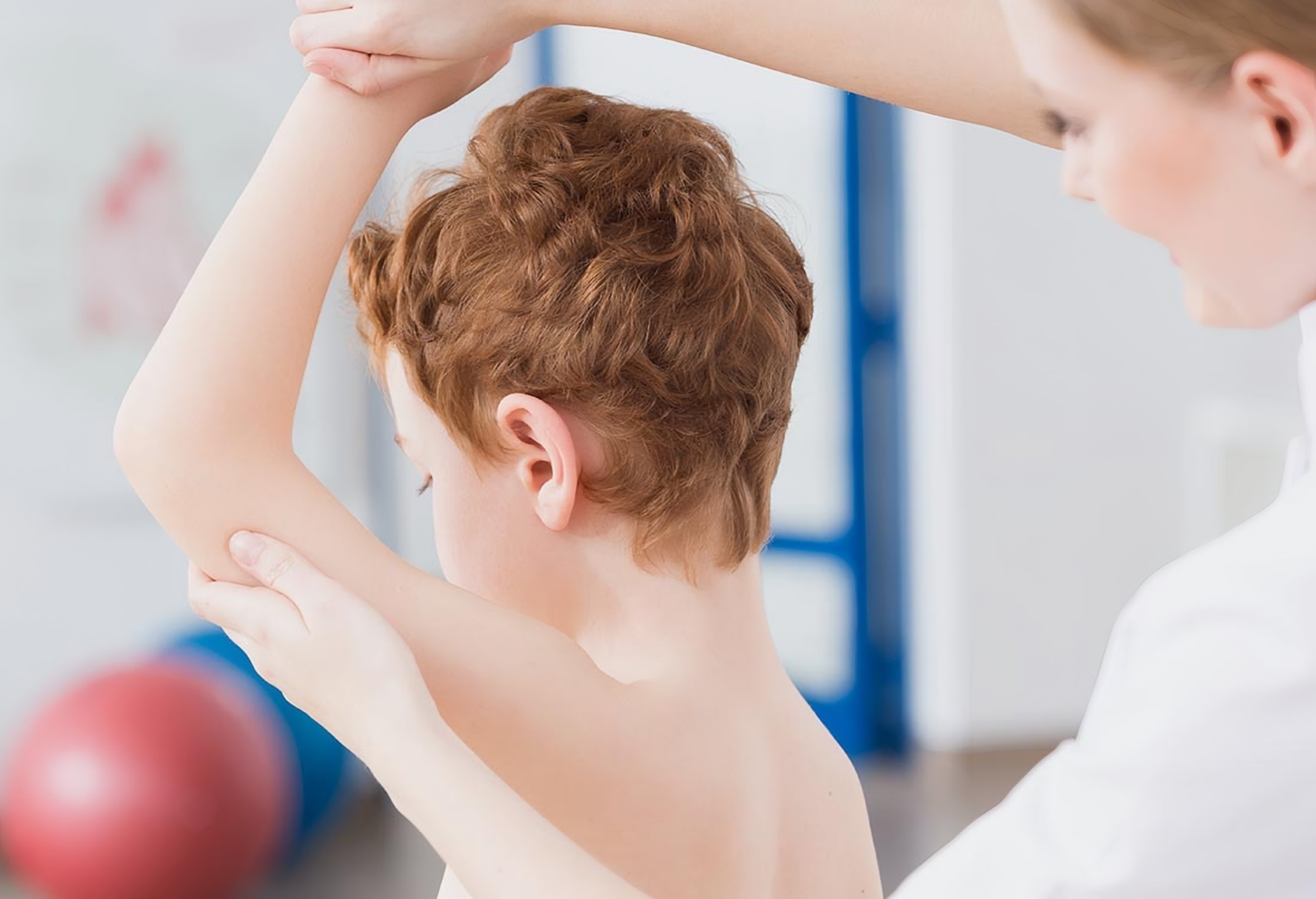 A doctor checks a boy's arm