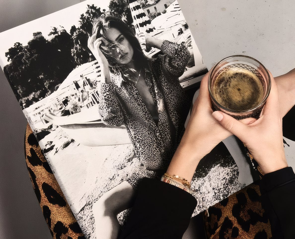 A black-and-white print and a glass on a leopard throw