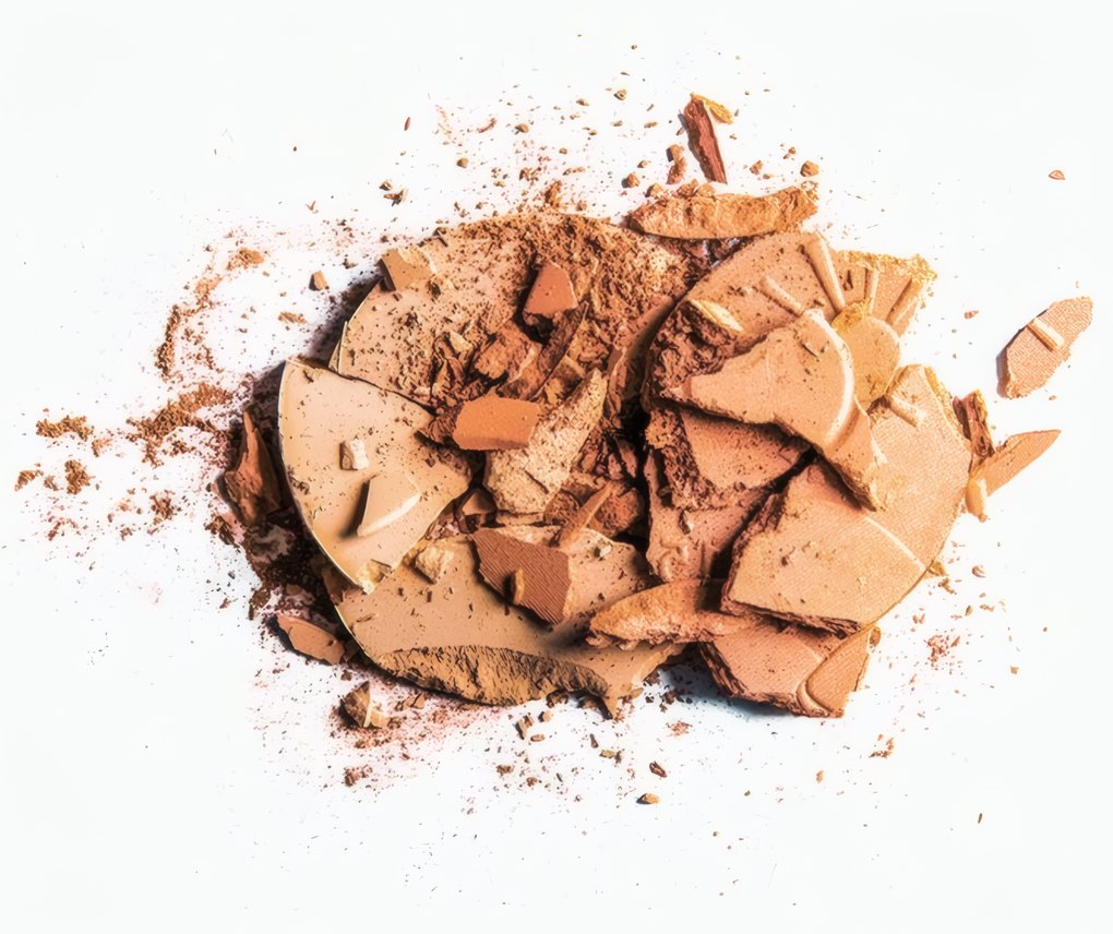 A pressed powder in warm peach, broken