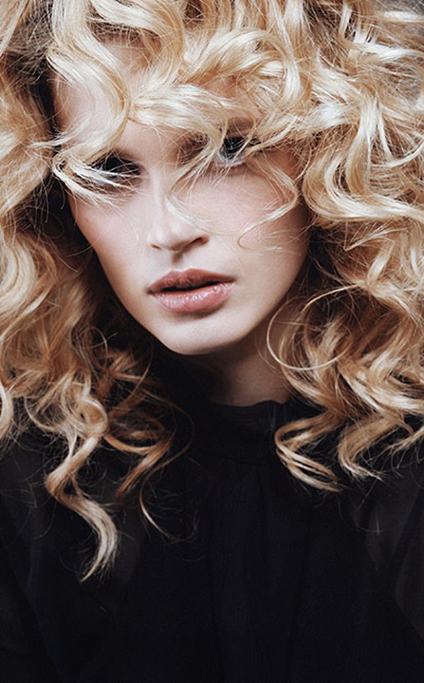 A client with pale curls in a black top