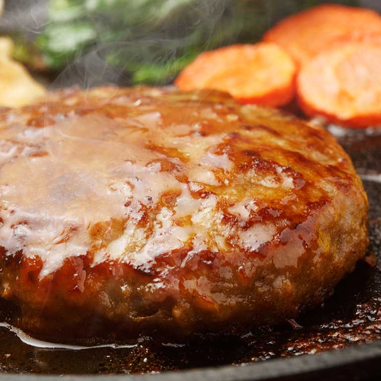 A glazed patty with sweet potato on a pan
