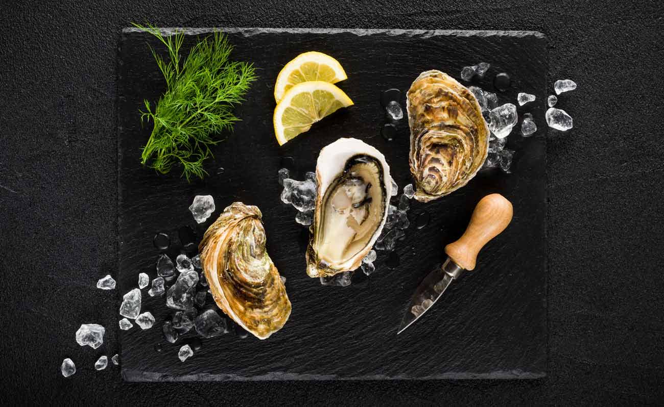 Oysters and lemon on slate