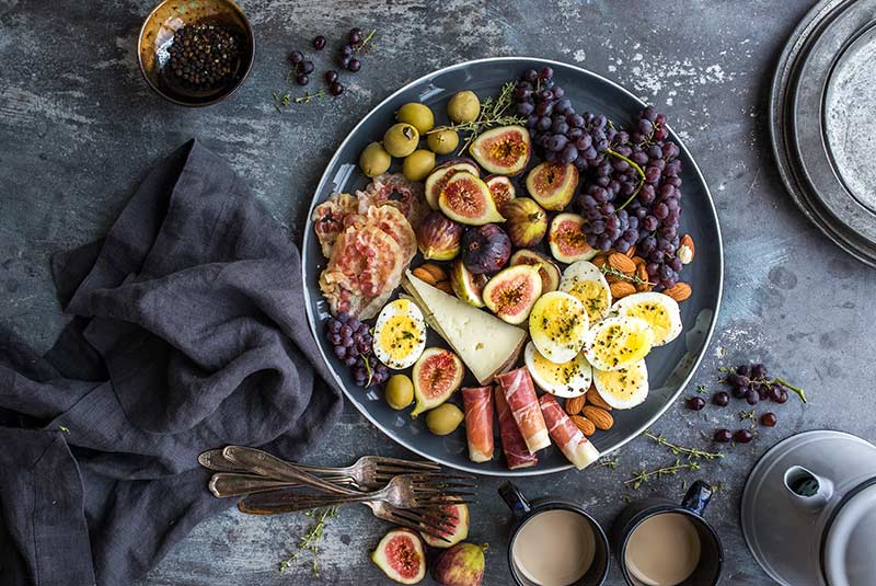 Figs, eggs and cured meats on a platter