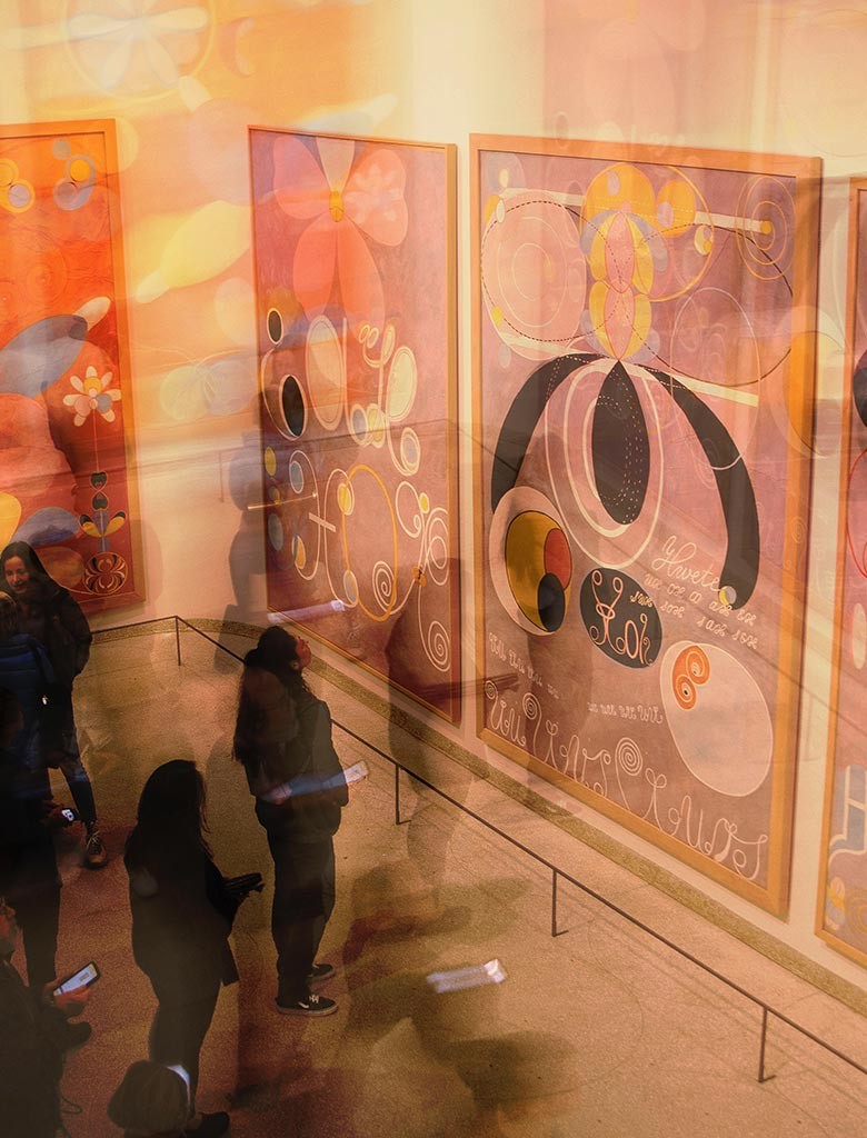 Visitors in a room of large abstract canvases