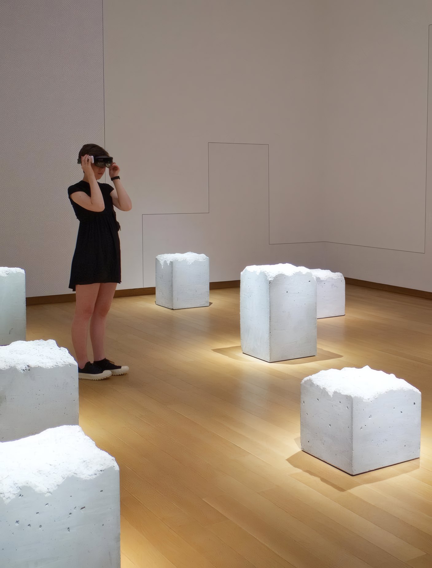 A visitor among white sculptures