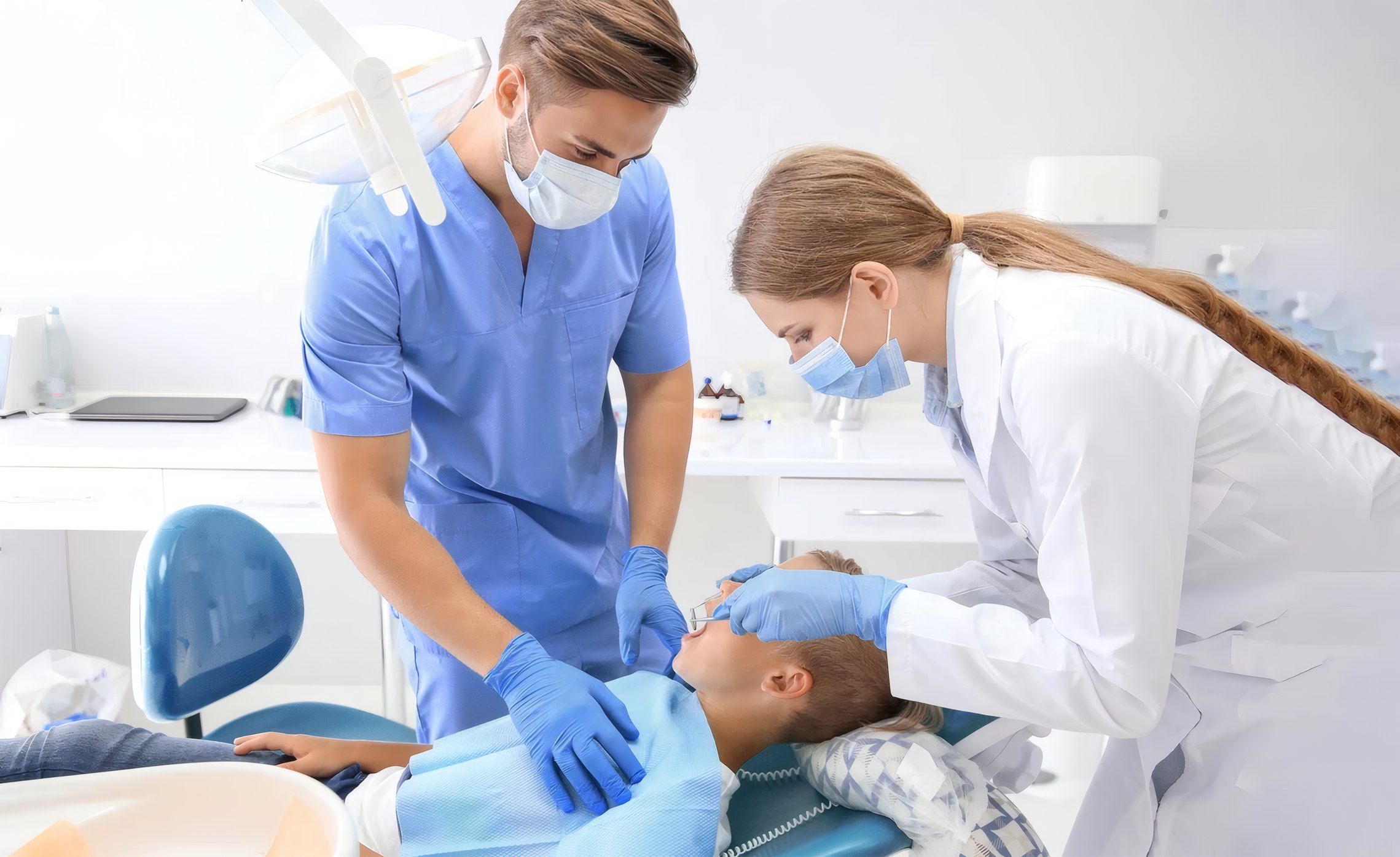 A dentist and assistant treating a patient