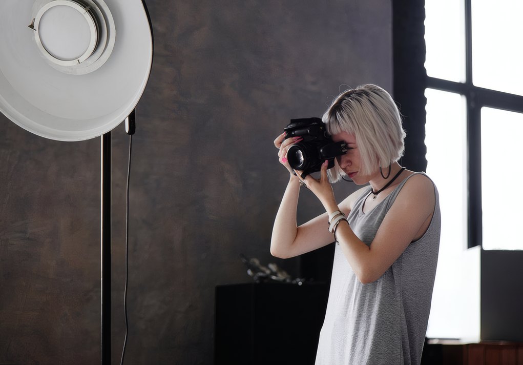 A photographer working under a beauty dish