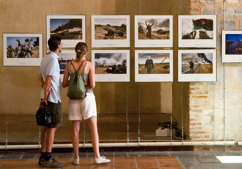 Visitors at an exhibition of prints