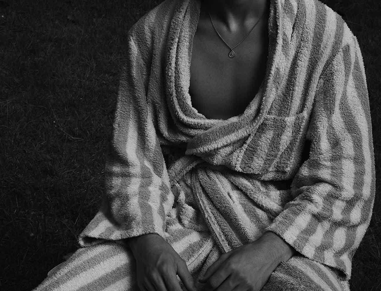 A man in a striped robe, in black and white