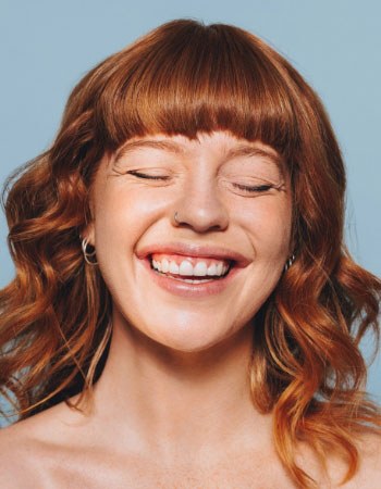 A laughing woman with red hair
