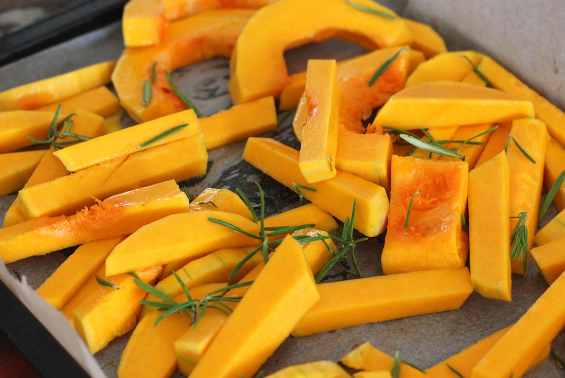 Roasted squash with rosemary on a baking tray