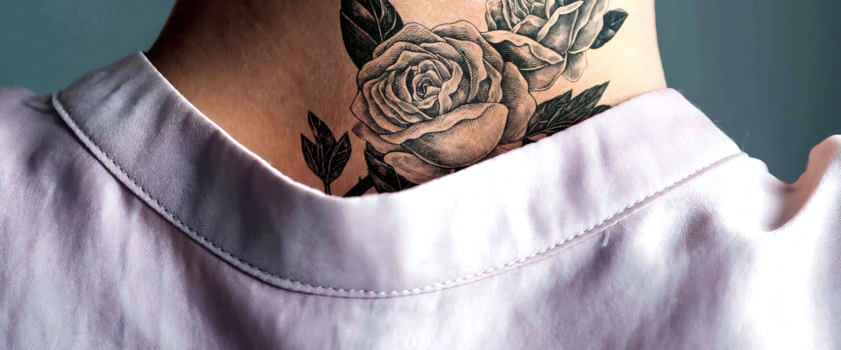 A fine-line rose at the nape of the neck