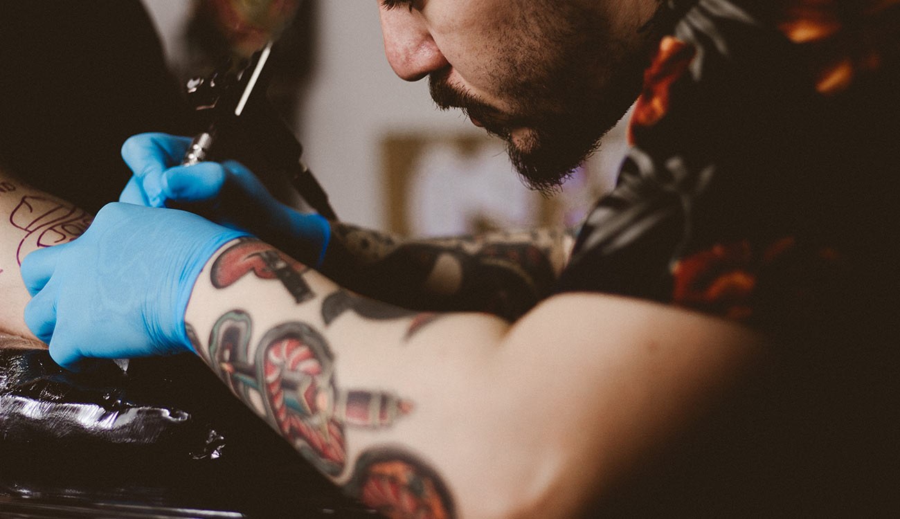 An artist pulling a fine line with a single needle