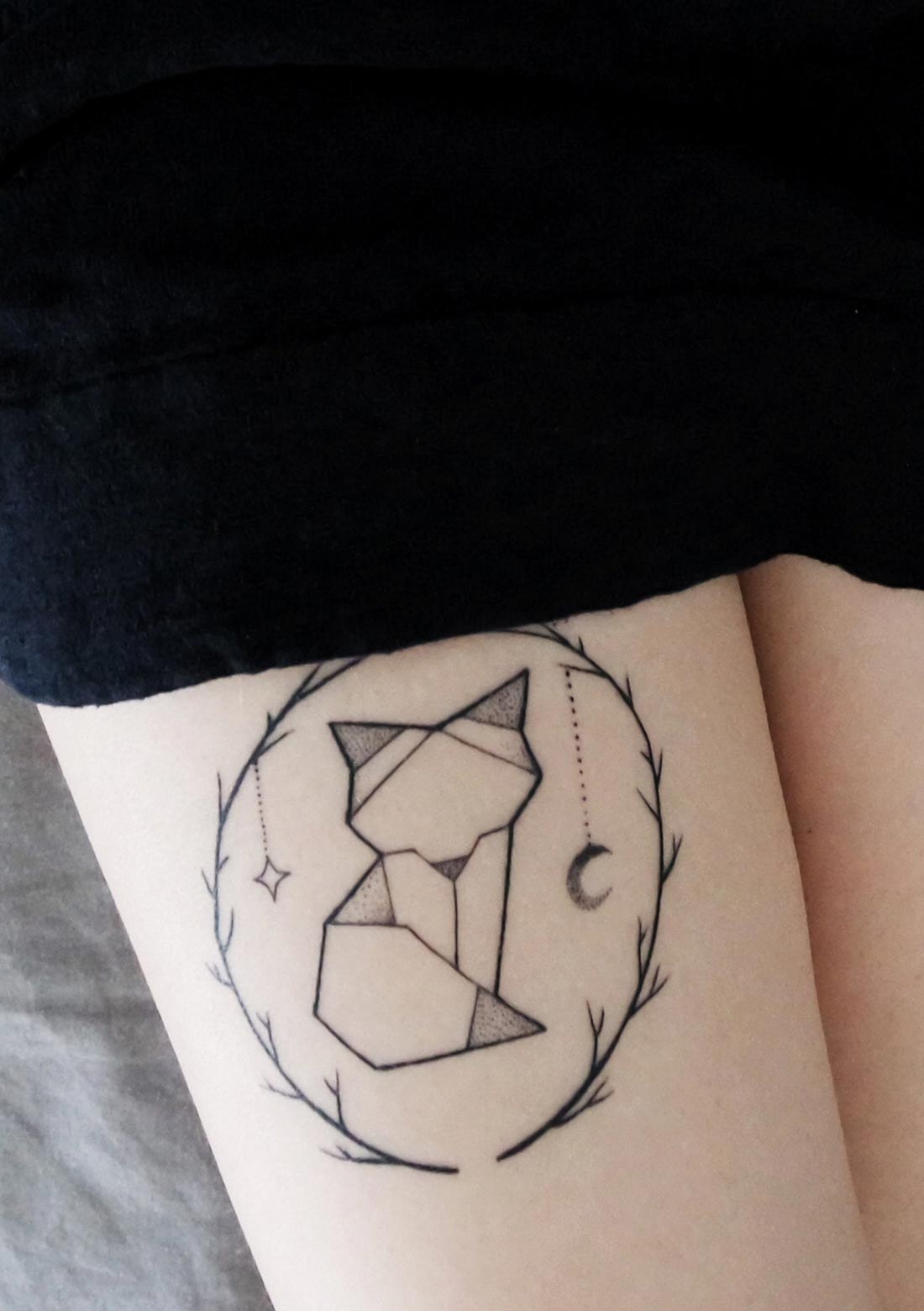 A geometric fine-line fox inside a wreath of thorns