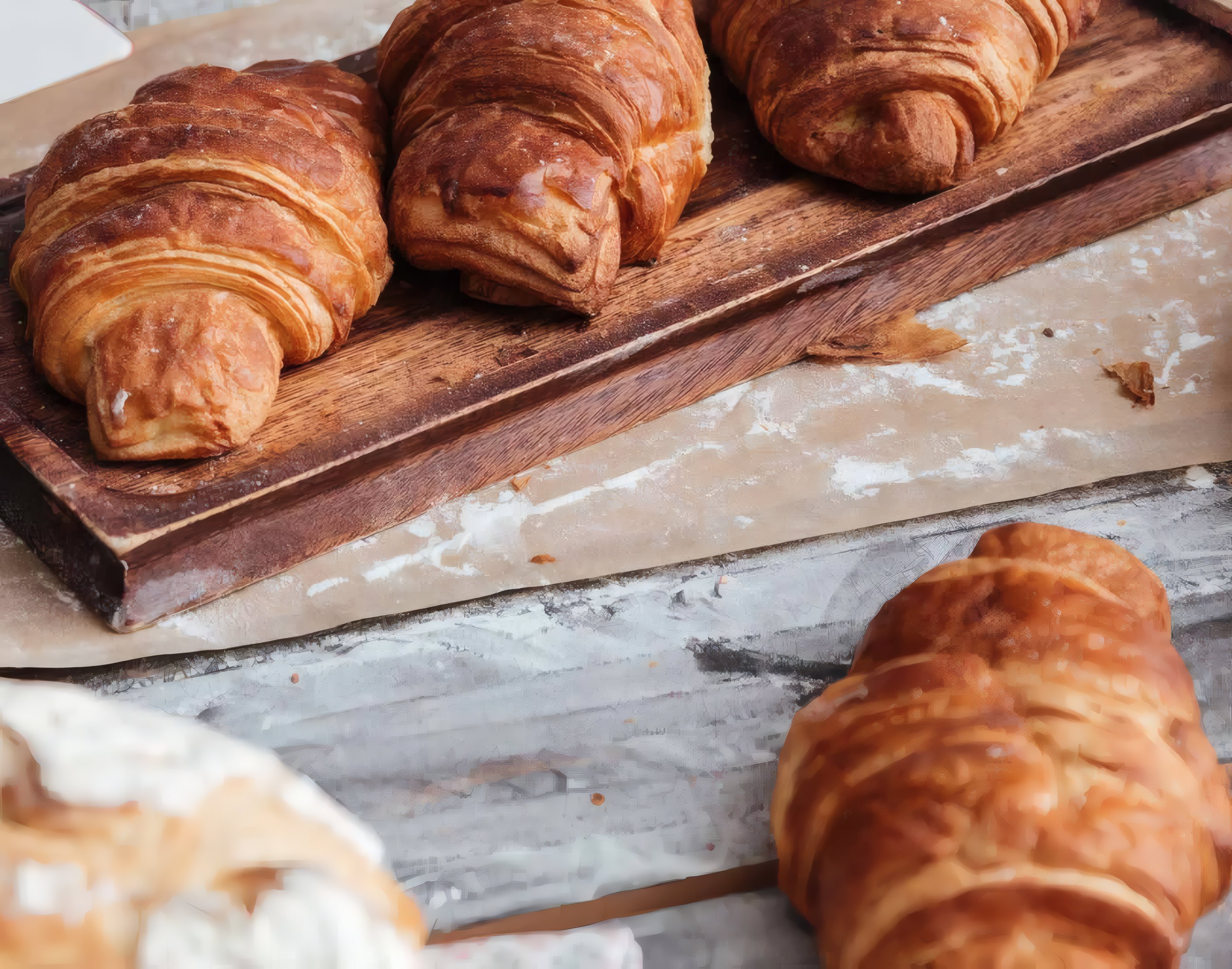 Croissants cooling on a wooden board