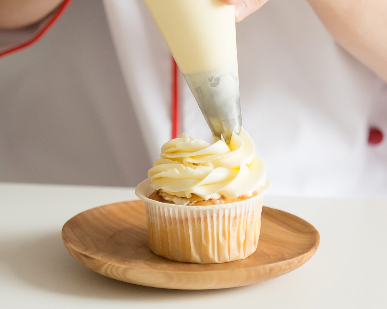 Buttercream piped onto a cupcake