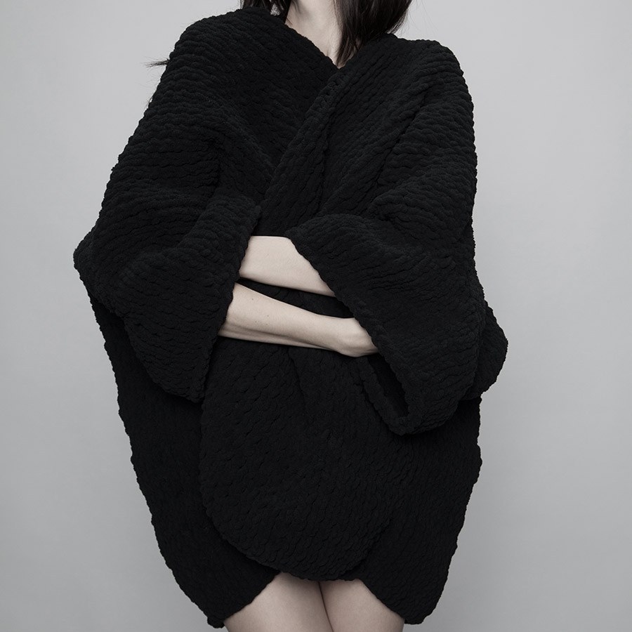 A black knit worn loose