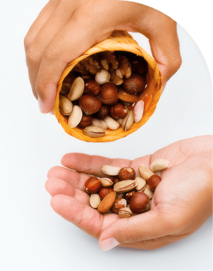 Hands pouring roasted nuts