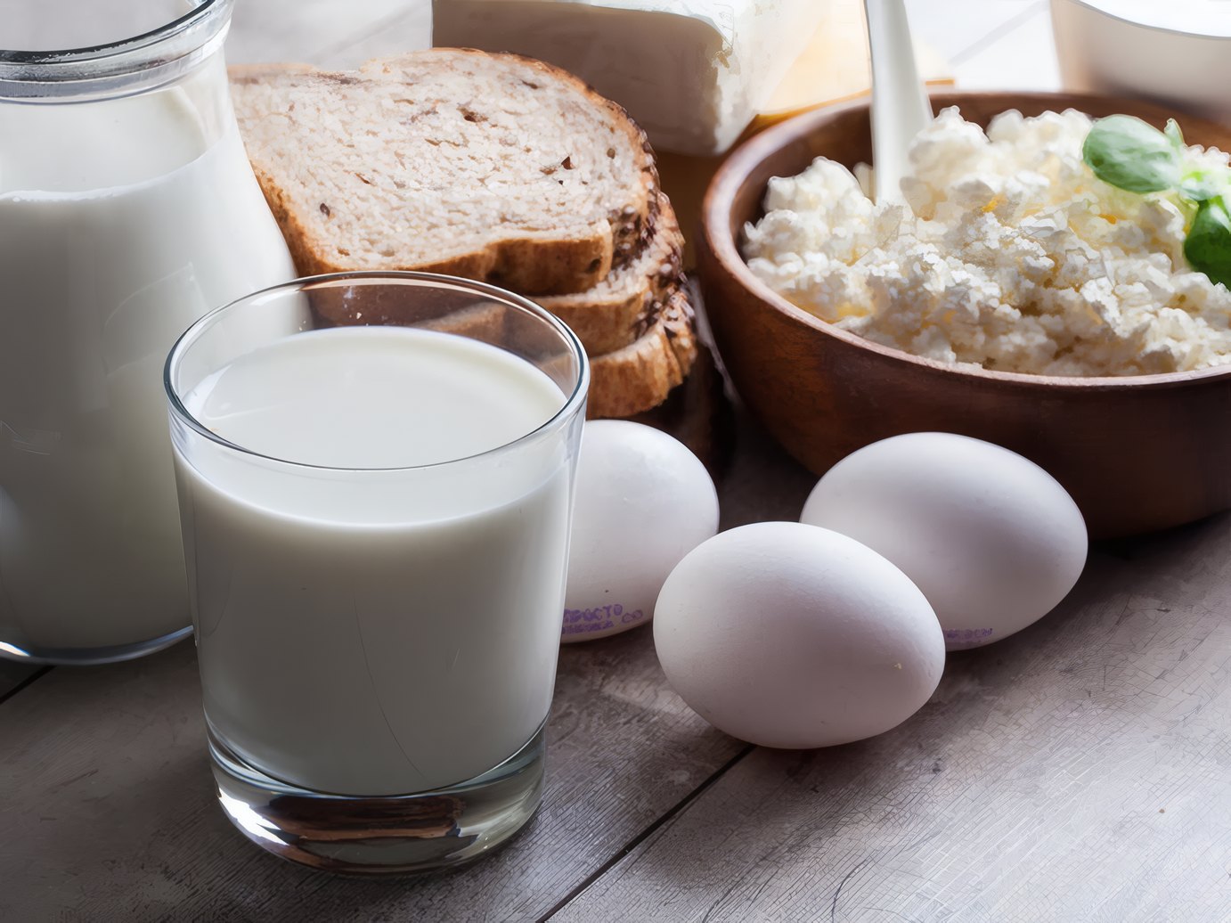 Milk, bread, eggs and fresh cheese on the farm table