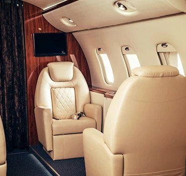 A cream leather seat by a cabin window