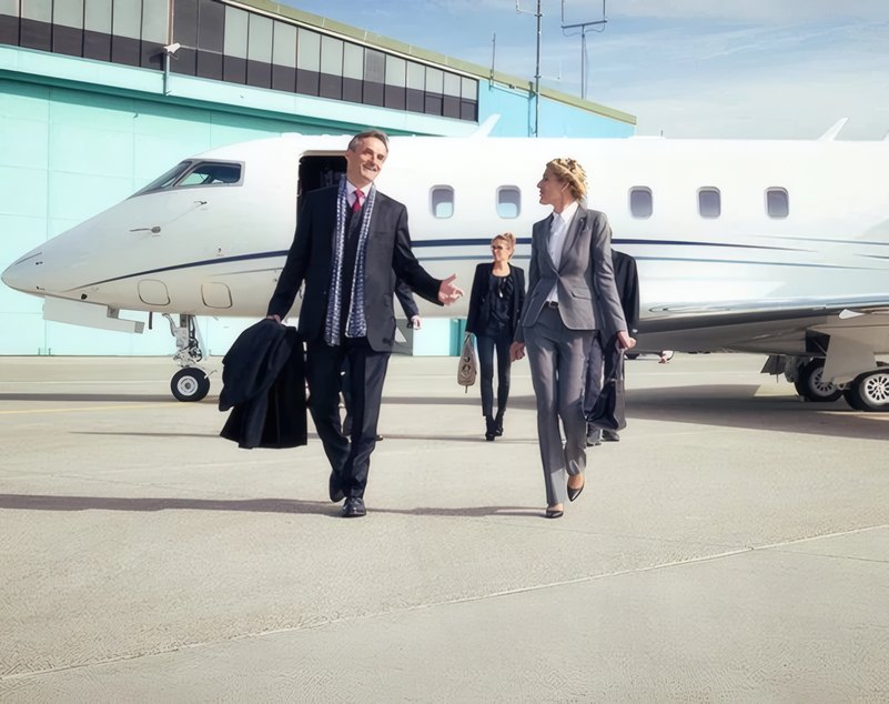 Travellers walking to their jet with the captain