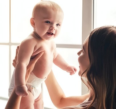 Mother holding up her laughing baby