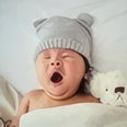 Baby under a lilac towel