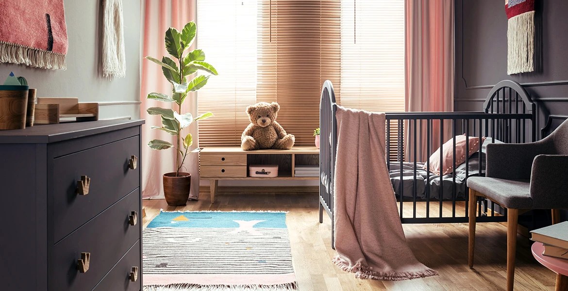 Bright nursery room with cots and soft chairs