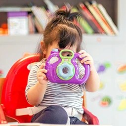 Little girl with a toy camera