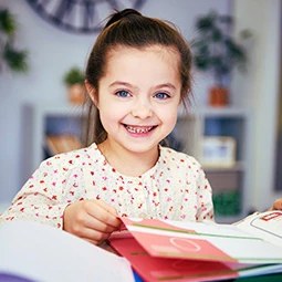 Smiling girl with a picture book