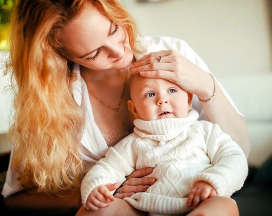 Mother stroking her baby's hair