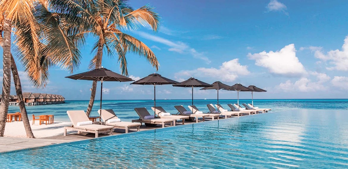 Loungers and umbrellas along the infinity pool