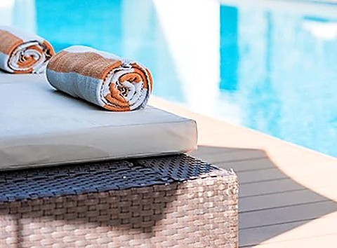A rolled towel beside the plunge pool