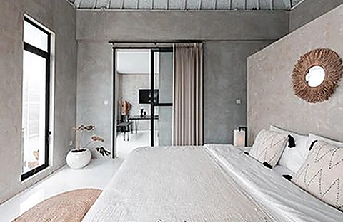 A lagoon villa bedroom opening onto the deck