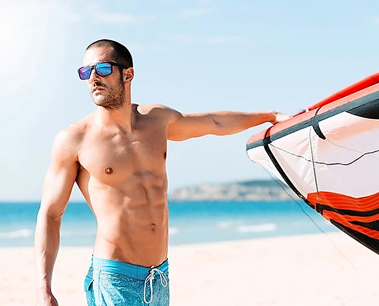 A windsurfer on the beach