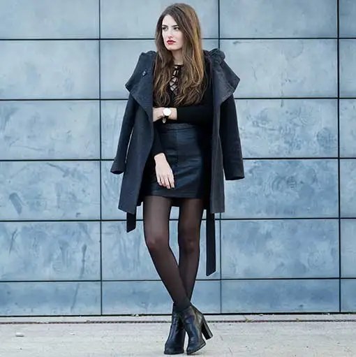 A black coat against a blue wall