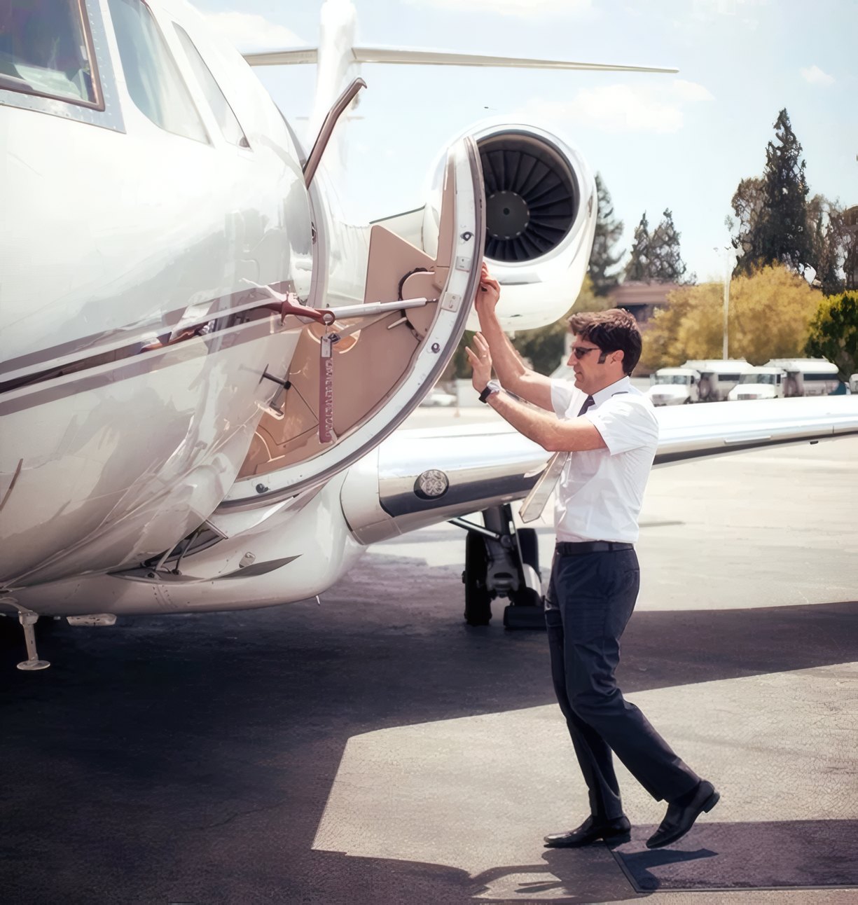 A pilot opening the door of a private jet